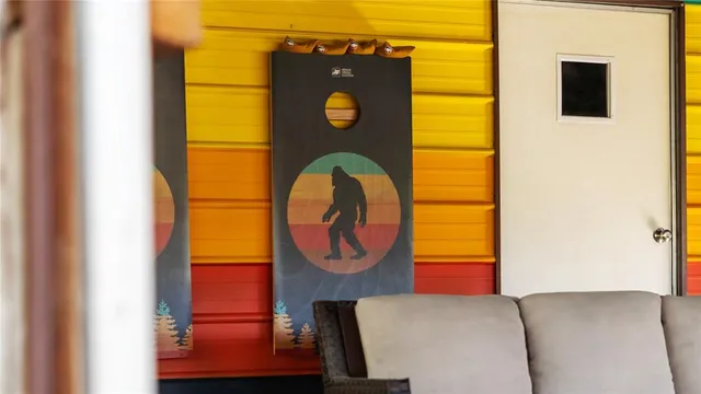 a living room with patio furniture and a floor to ceiling window