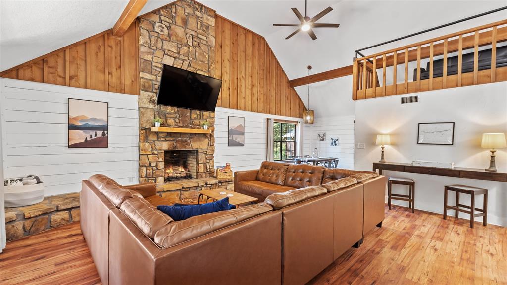 313 Post Oak Road Broken Bow, OK 74728 - Photo 3 of 40 a living room with furniture a flat screen tv and a fireplace