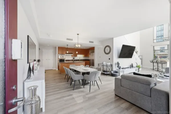 a living room with furniture kitchen view and a flat screen tv