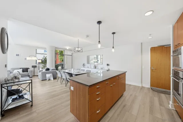 a kitchen with stainless steel appliances granite countertop a sink stove and wooden floor