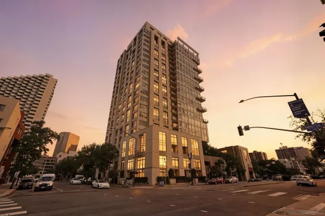 a view of a tall building next to a road