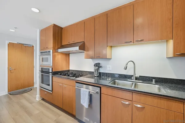 a kitchen with stainless steel appliances granite countertop a sink stove and refrigerator