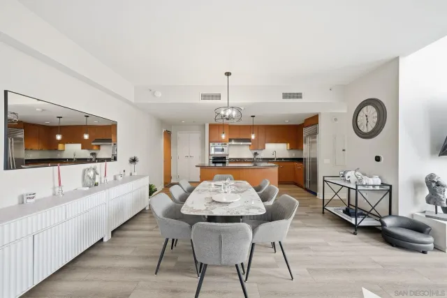 a dining room with furniture and a large window