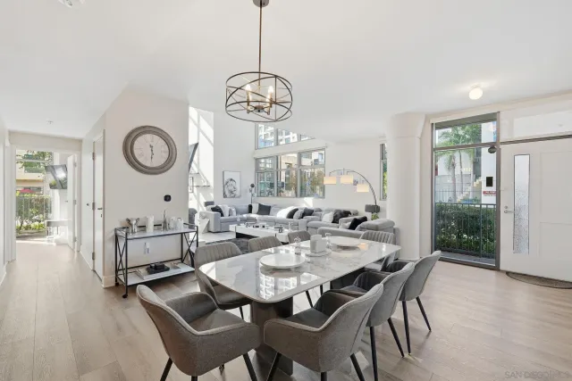 a view of a dining room with furniture wooden floor and a chandelier