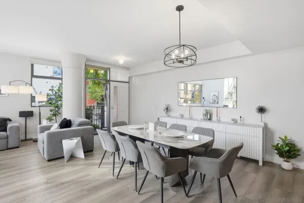 a view of a dining room with furniture window and wooden floor