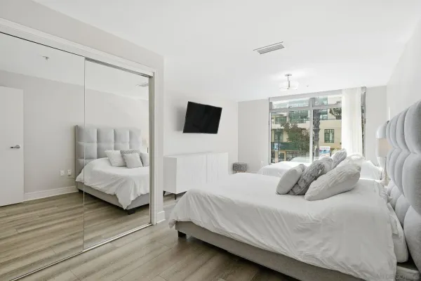 a bedroom with a bed and large window