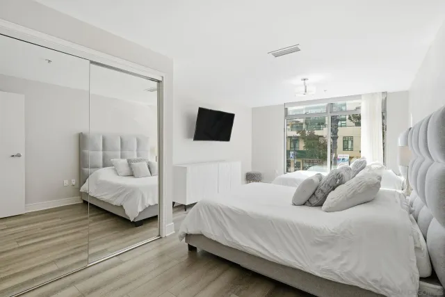 a bedroom with a bed and large window