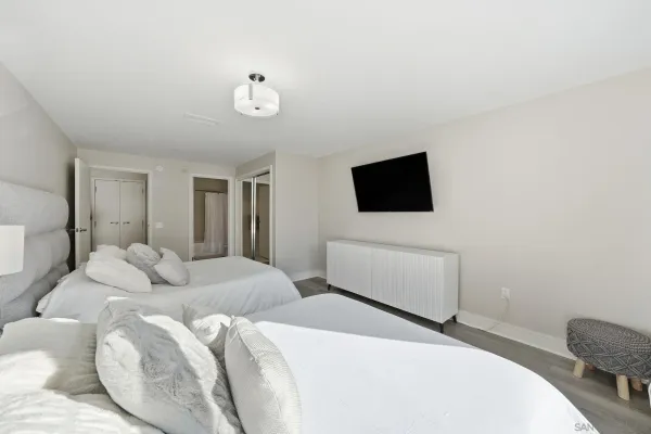 a bedroom with bed and a flat screen tv