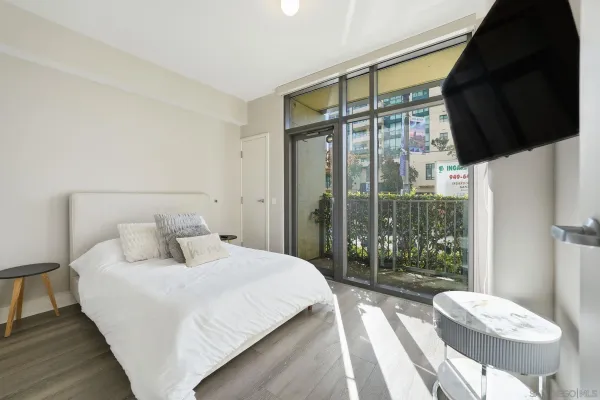 a bedroom with a bed and a large window
