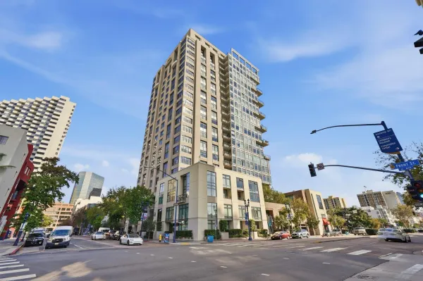 a view of a tall building next to a road