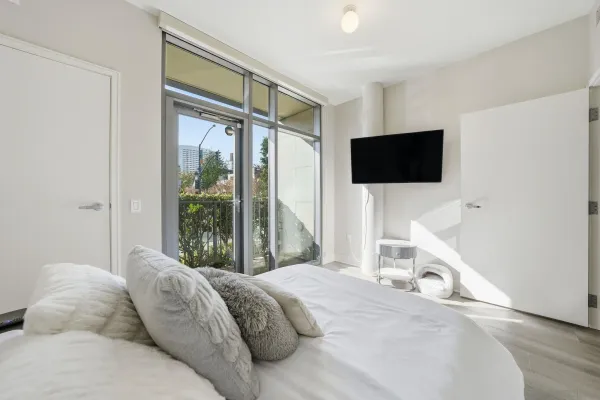 a bedroom with a bed and a flat screen tv