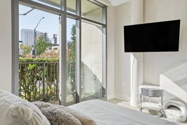 a bedroom with a bed and a flat screen tv