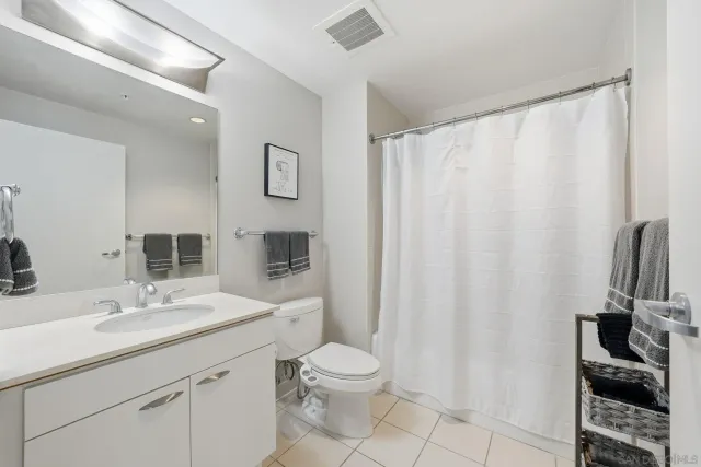 a bathroom with a toilet a sink and a mirror