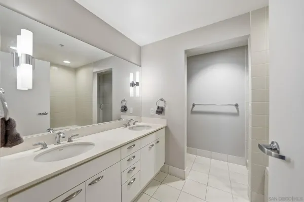 a bathroom with a double vanity sink and mirror