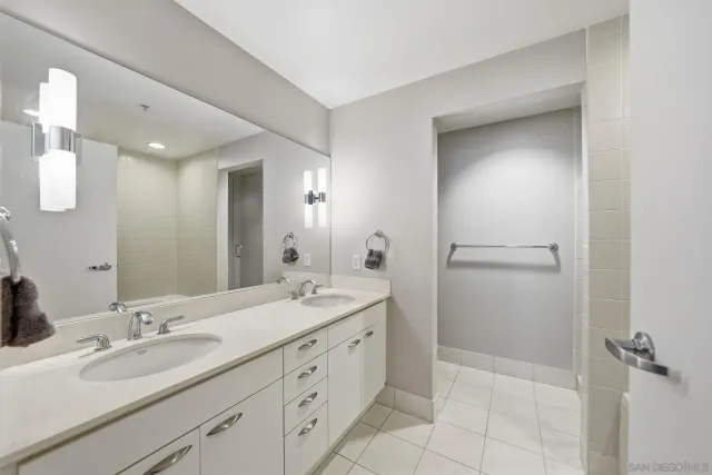 a bathroom with a double vanity sink and mirror