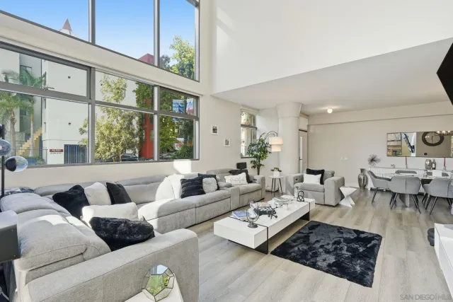 a living room with furniture or couch and a large window