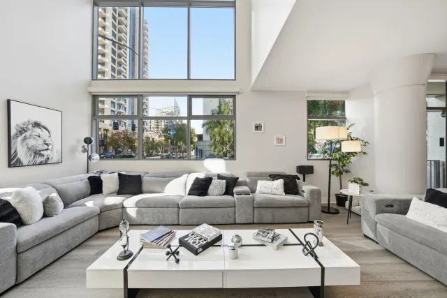 a living room with furniture large window and couch