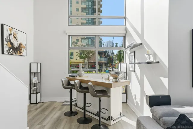 a view of a workspace with furniture and a window