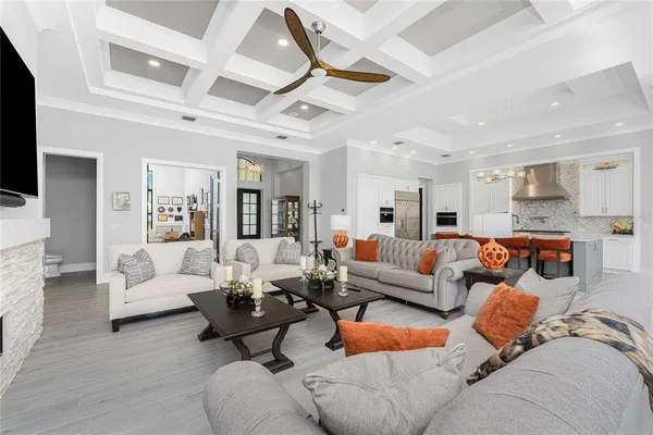 a kitchen with stainless steel appliances granite countertop a stove top oven a sink dishwasher and a refrigerator with wooden floor