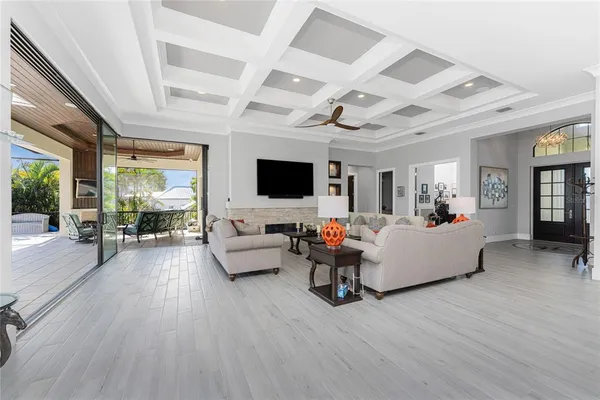 a view of kitchen with stainless steel appliances granite countertop a stove a sink a dining table and chairs