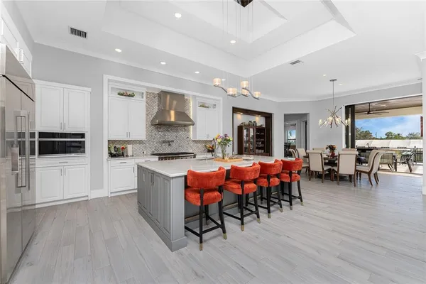 a living room with furniture and view of kitchen