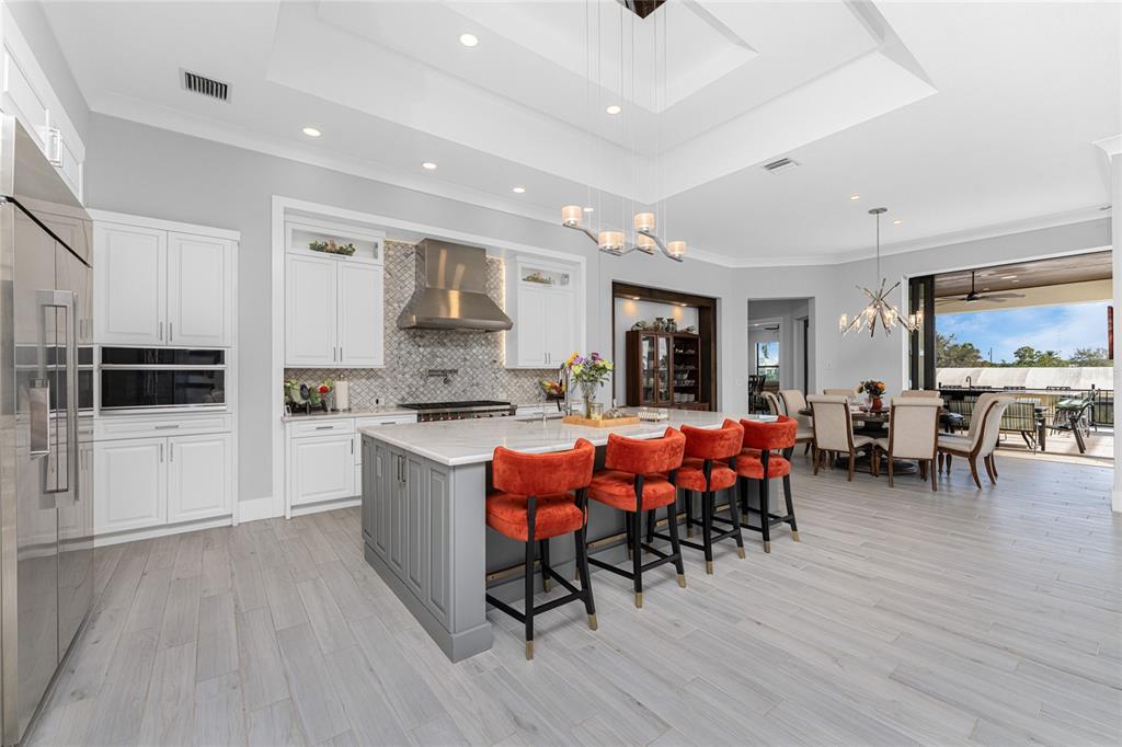 265 Severin Road Southeast Port Charlotte, FL 33952 - Photo 20 of 88 a large white kitchen with lots of furniture and stainless steel appliances