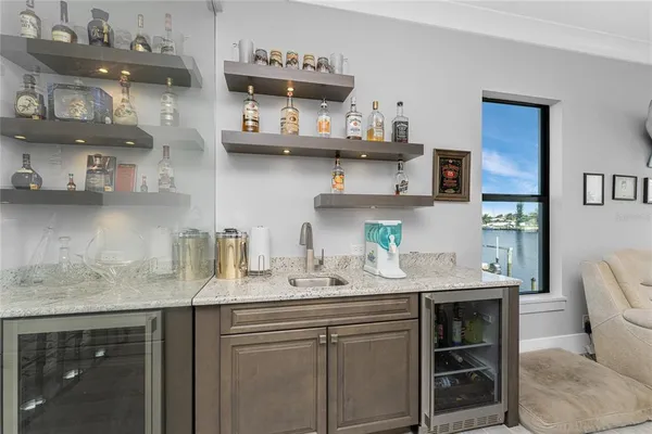 a spacious bathroom with a granite countertop sink a toilet a mirror and shower