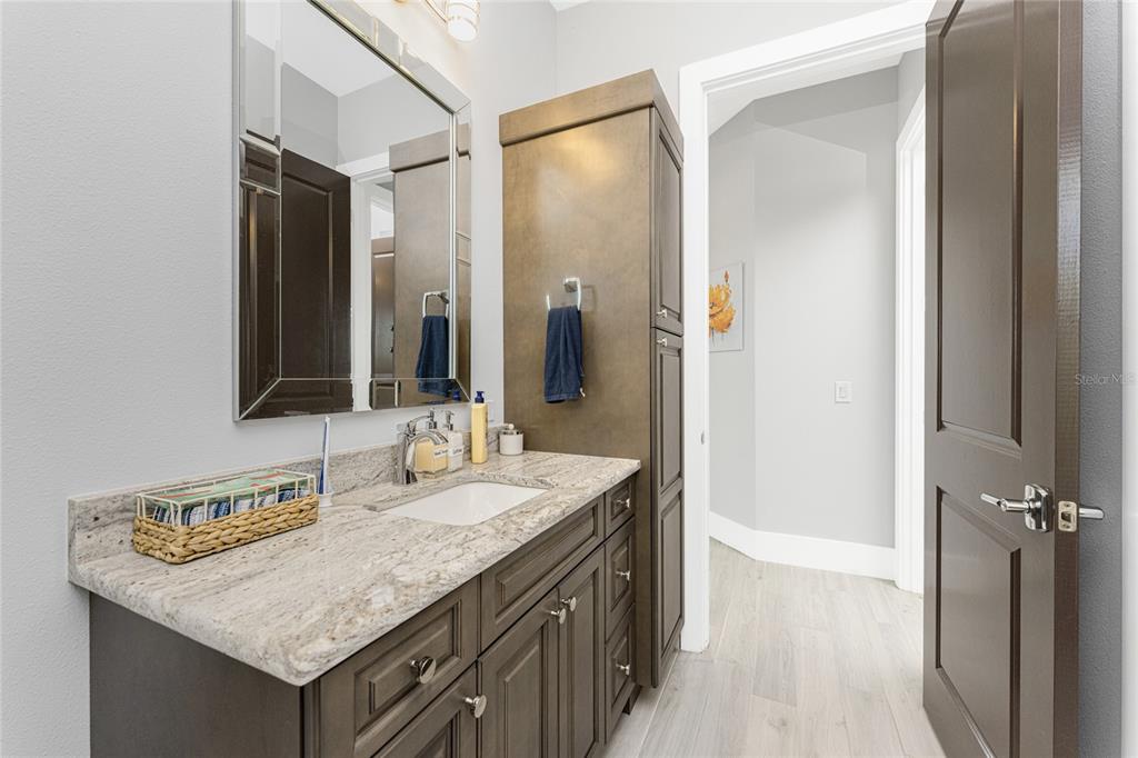 265 Severin Road Southeast Port Charlotte, FL 33952 - Photo 32 of 88 a bathroom with a granite countertop sink and a mirror