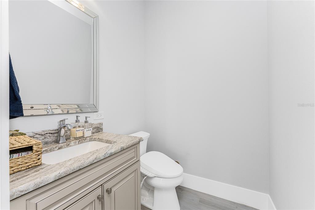 265 Severin Road Southeast Port Charlotte, FL 33952 - Photo 33 of 88 a bathroom with a granite countertop sink and a toilet