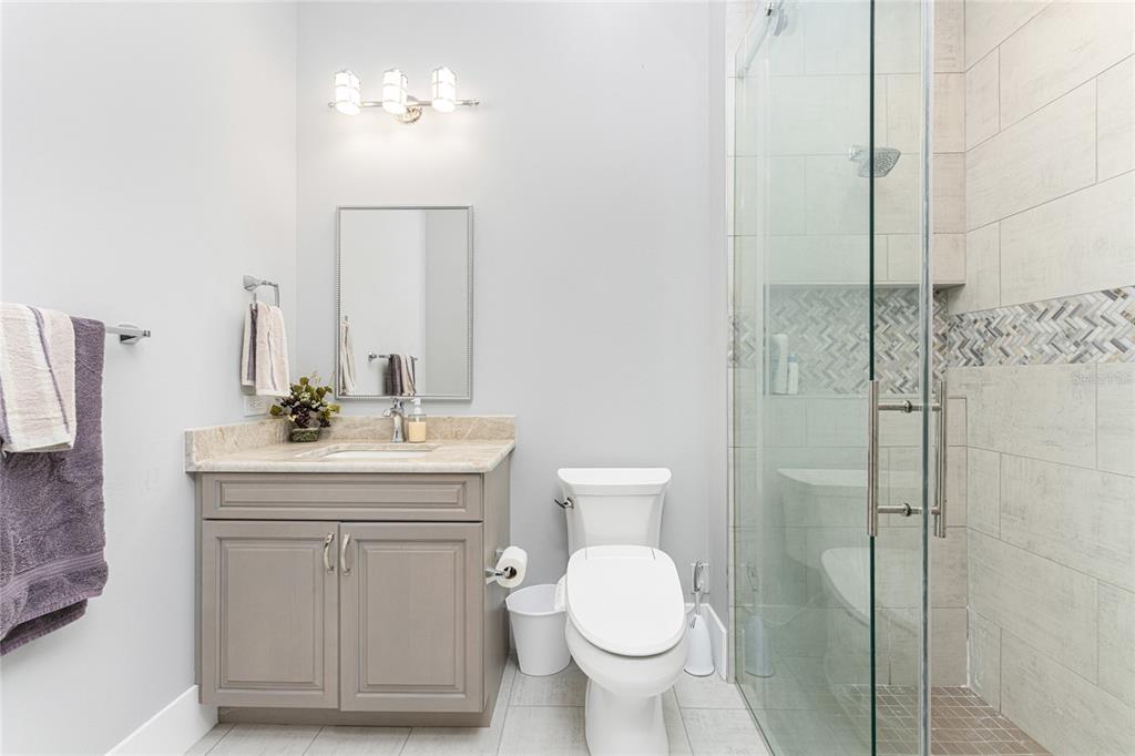 265 Severin Road Southeast Port Charlotte, FL 33952 - Photo 48 of 88 a bathroom with a toilet a sink a mirror and vanity