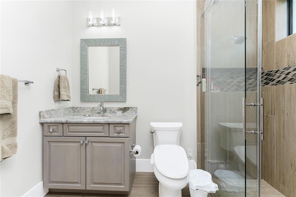 265 Severin Road Southeast Port Charlotte, FL 33952 - Photo 52 of 88 a bathroom with a granite countertop toilet sink and mirror