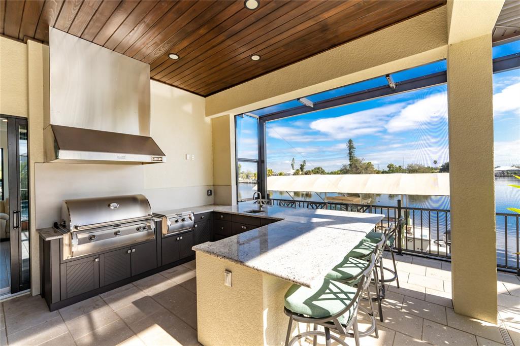 265 Severin Road Southeast Port Charlotte, FL 33952 - Photo 60 of 88 a kitchen with a stove a refrigerator and a dining table