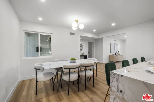 a kitchen with stainless steel appliances granite countertop a sink a stove and a refrigerator