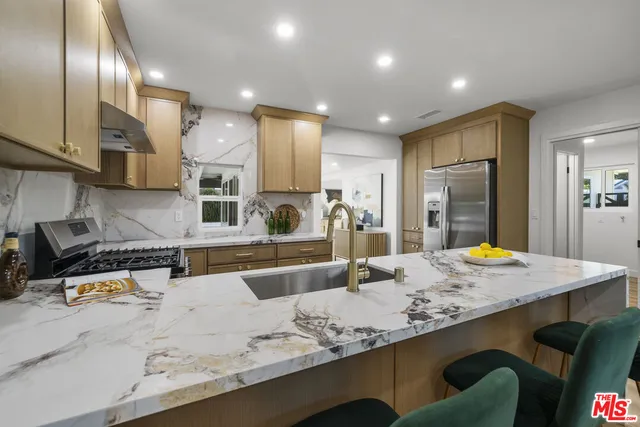 a view of a patio with table and chairs and wooden floor