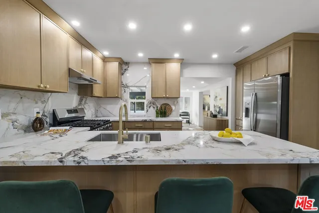 a living room with furniture a wooden floor and a large window