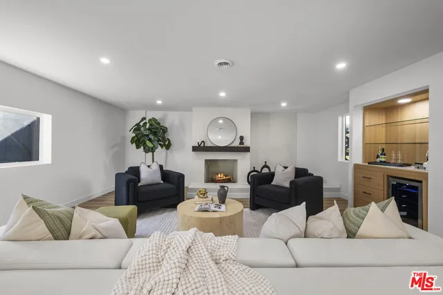 a view of an entryway with wooden floor and a workspace