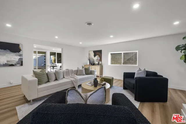 a view of a dining room with furniture and a window
