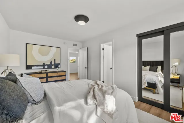 a view of a room that has wooden floor and a window