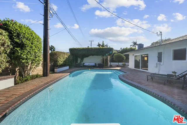 a backyard of a house with table and chairs