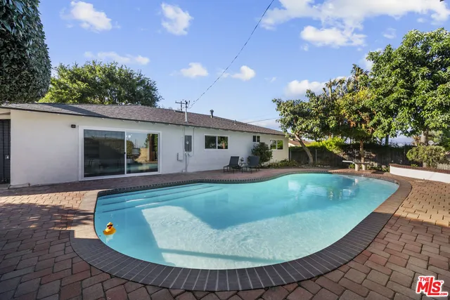 a view of a house with a yard and tree