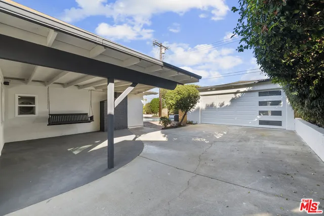 an aerial view of residential house with outdoor space and swimming pool