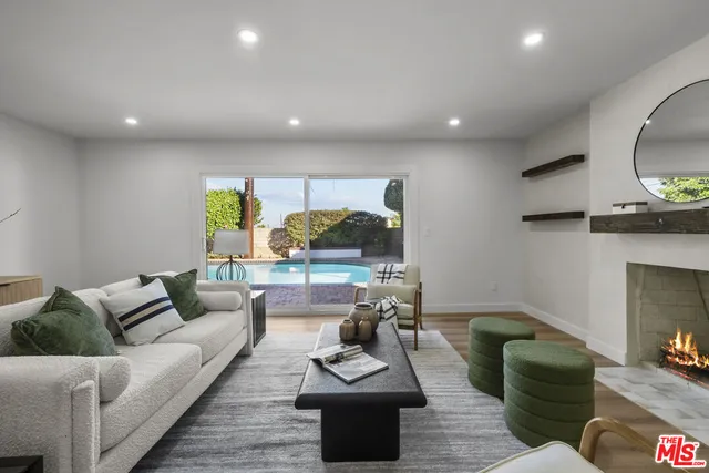 a living room with fireplace furniture and a wooden floor