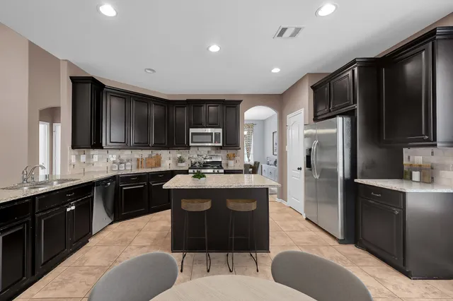 a kitchen with a sink stove and microwave