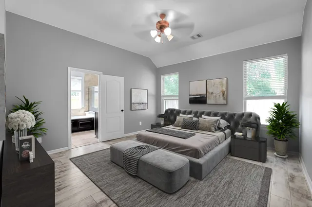 a bedroom with furniture and a window