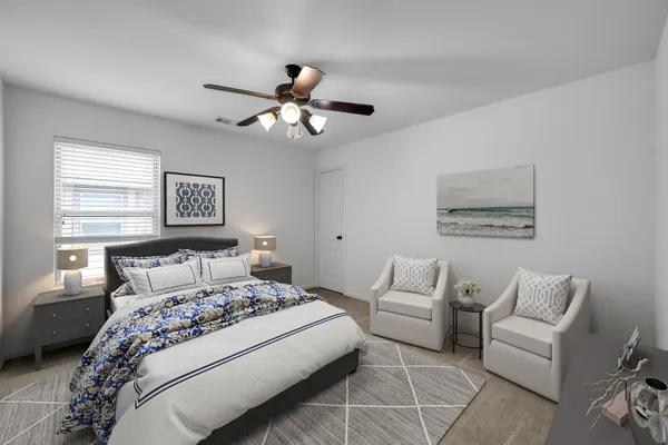a bedroom with a bed dresser and wooden floor