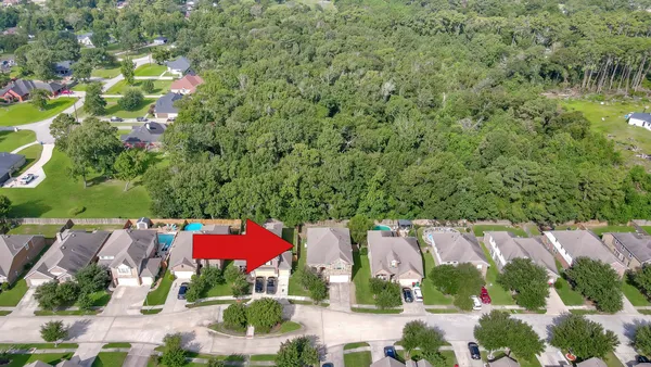 an aerial view of residential houses with outdoor space and lake view