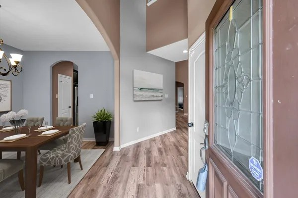 a view of a dining room with furniture and chandelier