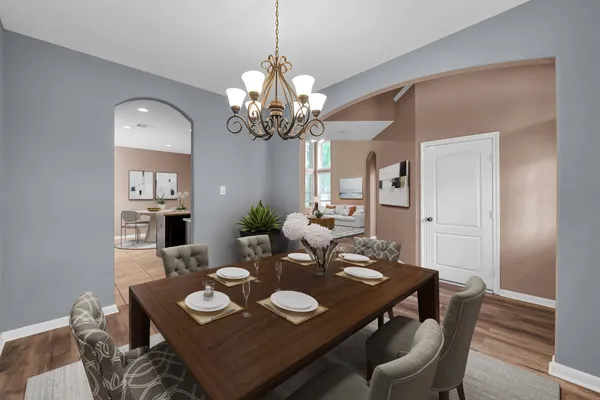 a dining room with furniture a chandelier and window