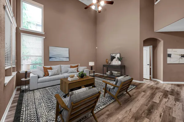 a living room with furniture and wooden floor