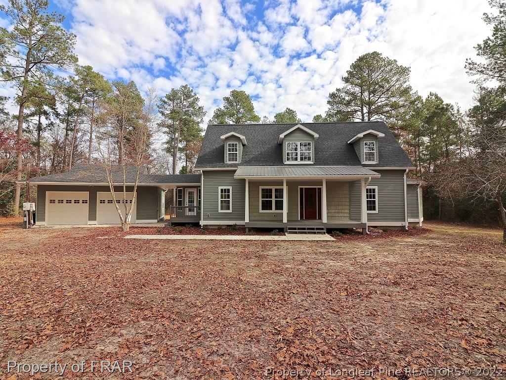 873 Morrison Bridge Road Vass, NC 28394 - Photo 1 of 35 a front view of a house with a garden